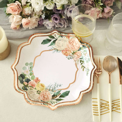 Floral decorative paper plate with gold trim on a table setting.