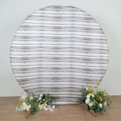 Decorative round backdrop with floral arrangements on the sides.