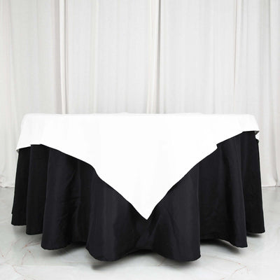 Black and white tablecloth draped over a round table