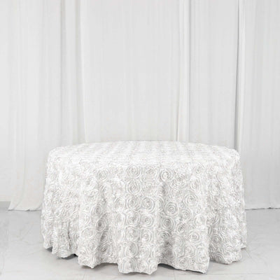 Round white tablecloth with rose pattern on plain backdrop