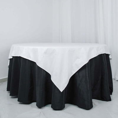 Round table with black tablecloth and white overlay