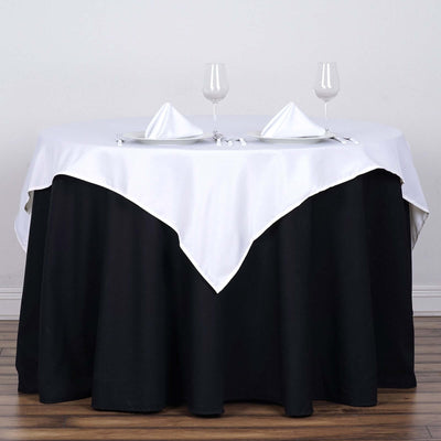 Elegant black and white dining table setup with glasses and napkins.