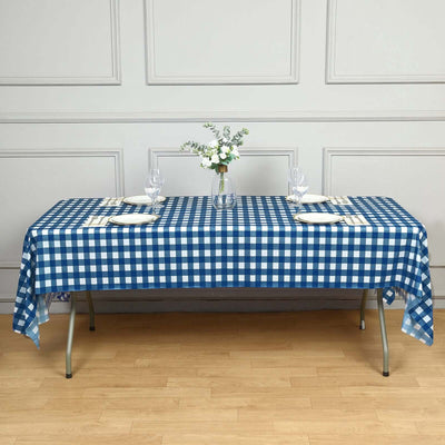 Blue and white gingham tablecloth on a dining table set for two.