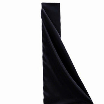 Black fabric draped elegantly in studio isolation.